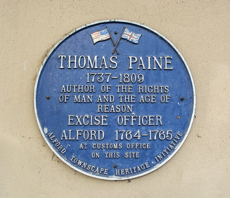 Plaque marking the building in Alford, UK where Paine worked as an excise officer from 1764 to 1765 at customs office on this site – Photo by TonyMo22